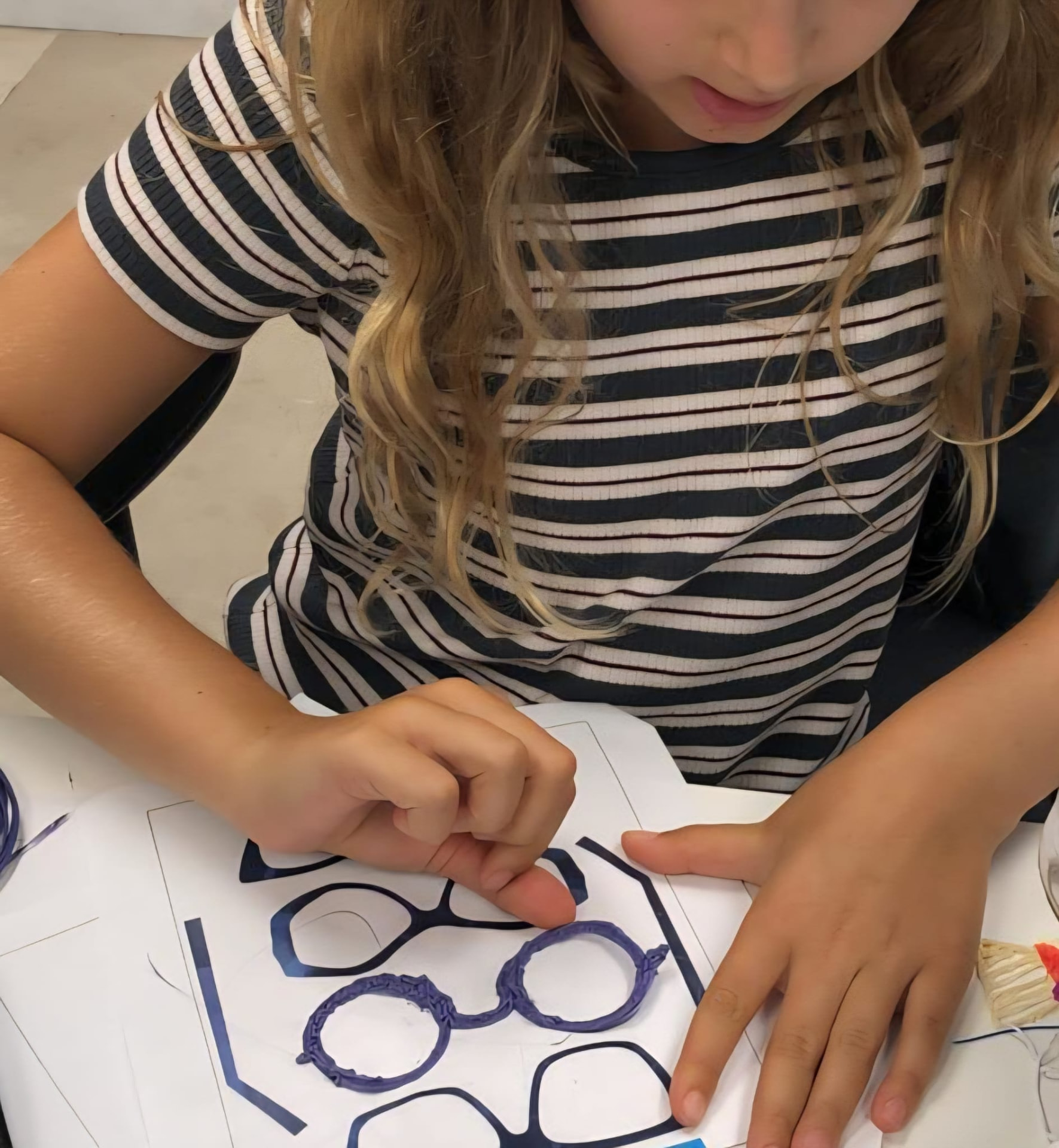 Criança a criar uns óculos com a caneta Create3D